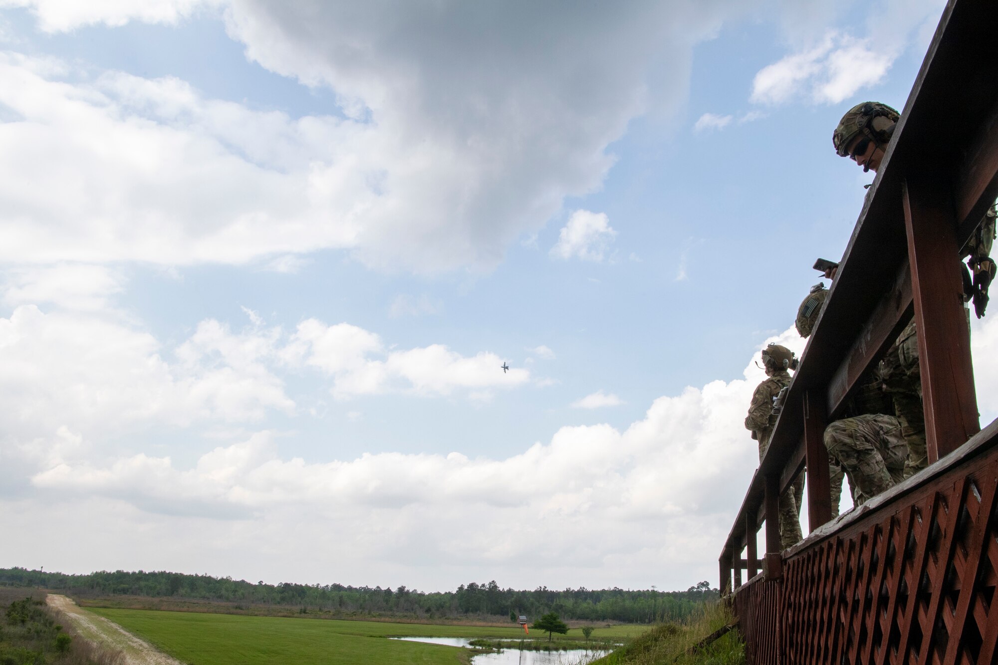 TACP Airmen stand on a platform