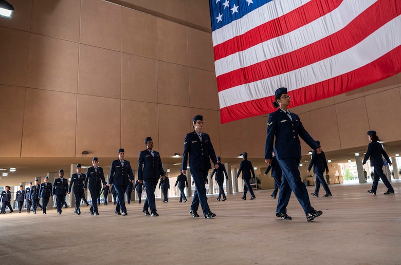 Airmen walk in formation during their basic military graduation