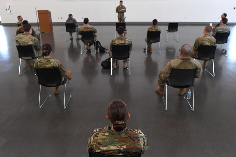 Airmen receive instructions from COVID-19 response team