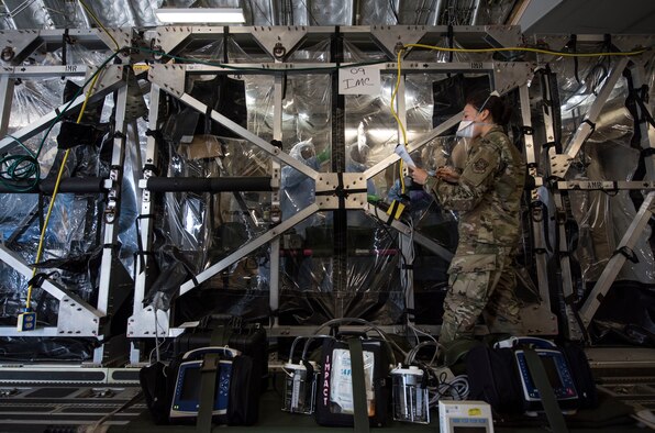 U.S Air Force Capt. Naomi King, 628th Operational Medical Readiness Squadron infectious disease team lead, reviews COVID-19 cleaning procedures with Airmen in the Transport Isolation System at Joint Base Charleston, South Carolina, April 5, 2020. The TIS is an infectious disease containment unit designed to minimize risk to aircrew and medical attendants, while allowing in-flight medical care for patients affected by contagions like COVID-19. MEDCREW, a combination of Aeromedical Evacuation flight nurses and technicians, Critical Care Air Transport teams, Infectious Disease specialists, and TIS support team members, participated in multi-day training at Joint Base Charleston to focus on patient movement using the TIS. The training involved learning how to don and doff personal protective equipment specific to COVID-19, preparing patients for evacuation, loading and unloading patients from the TIS, and configuring the C-17 Globemaster III for patient movement. (U.S. Air Force photo by Senior Airman Allison Payne)