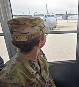 Soldier looks through bus window.
