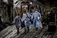 Three U.S. Air Force medical Airmen exit a C-17 Globemaster III aircraft following the first-ever operational use of the Transport Isolation System at Ramstein Air Base, Germany, April 10, 2020. The TIS is an infectious disease containment unit designed to minimize contamination risk to aircrew and medical attendants, while allowing in-flight medical care for patients afflicted by a disease--in this case, COVID-19. (U.S. Air Force photo by Staff Sgt. Devin Nothstine)