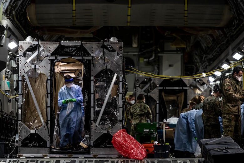 U.S. Air Force Airmen aboard a C-17 Globemaster III aircraft begin disinfecting and decontaminating the aircraft after the first-ever operational use of the Transport Isolation System at Ramstein Air Base, Germany, April 10, 2020. The TIS is an infectious disease containment unit designed to minimize contamination risk to aircrew and medical attendants, while allowing in-flight medical care for patients afflicted by a disease--in this case, COVID-19. (U.S. Air Force photo by Staff Sgt. Devin Nothstine)