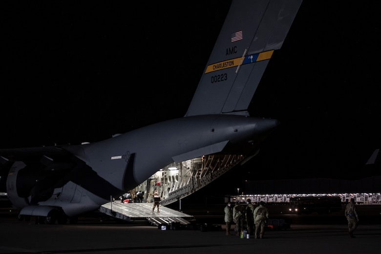 U.S. Air Force Airmen unload medical equipment after transporting COVID-19 patients during the first-ever operational use of the Transport Isolation System at Ramstein Air Base, Germany, April 10, 2020. The TIS is an infectious disease containment unit designed to minimize contamination risk to aircrew and medical attendants, while allowing in-flight medical care for patients afflicted by a disease--in this case, COVID-19. (U.S. Air Force photo by Staff Sgt. Devin Nothstine)