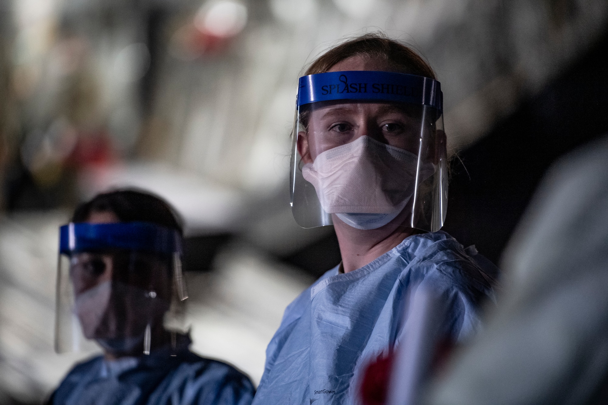 A U.S. Air Force medical Airman awaits patient documentation      following the first-ever operational use of the Transport Isolation System at Ramstein Air Base, Germany, April 10, 2020. The TIS is an infectious disease containment unit designed to minimize contamination risk to aircrew and medical attendants, while allowing in-flight medical care for patients afflicted by a disease--in this case, COVID-19. (U.S. Air Force photo by Staff Sgt. Devin Nothstine)
