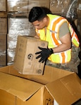 Spc. Edgar Mendez, an automated logistical specialist, loads personal protective equipment while on State Active Duty as part of the Wisconsin National Guard’s response to COVID-19.