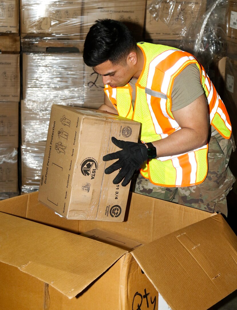 Spc. Edgar Mendez, an automated logistical specialist, loads personal protective equipment while on State Active Duty as part of the Wisconsin National Guard’s response to COVID-19.