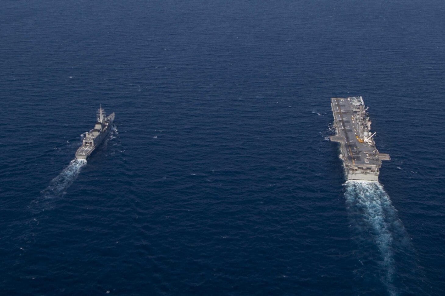 Amphibious assault ship USS America (LHA 6) and Japan Maritime Self-Defense Force destroyer JS Akebono (DD 108) sail in formation in the East China Sea. America, flagship of the America Expeditionary Strike Group, 31st Marine Expeditionary Unit team is operating in the 7th Fleet area of operations to enhance interoperability with allies and partners and serve as a ready response force to defend peace and stability in the Indo-Pacific region