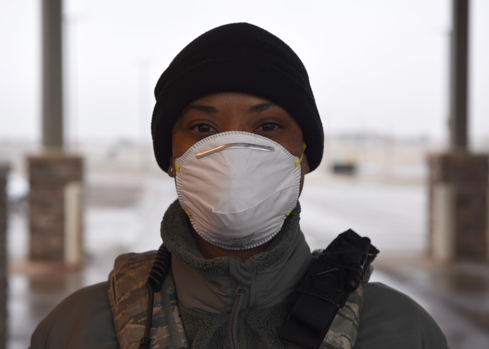 U.S. Air Force Airman 1st Class Laurente Drake, 460th Security Forces Squadron member, poses for a photo on April 2, 2020 at Buckley Air Force Base, Colo. Buckley AFB is currently in Health Protection Condition level Charlie in response to the spread of COVID-19 in the state of Colorado and to Members manning the gate are required to wear personal protective equipment and practice proper social distancing due to the risks associated with COVID-19. The HPCON Charlie defines base measures for a substantial disease threat and ensures Team Buckley is using the proper protocols and processes to prevent transmission. (U.S. Air Force photo by Airman 1st Class Haley N. Blevins)