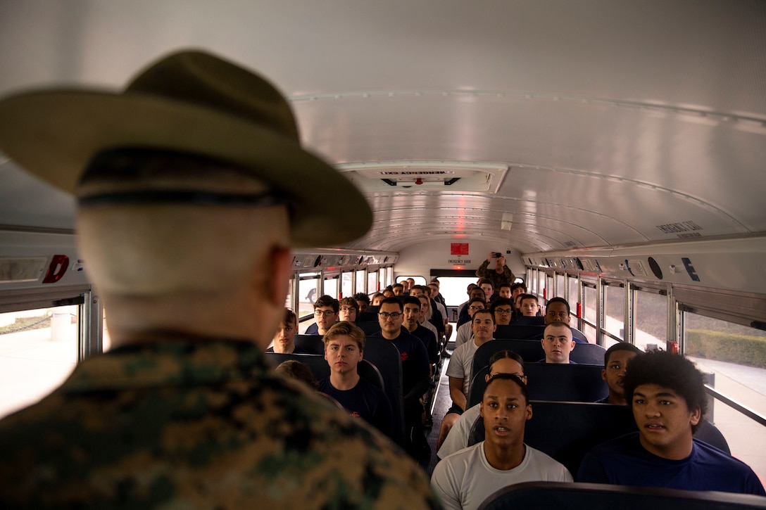 A United States Marine Corps drill instructor directs poolees to get off the bus and into the staging area at Recruiting Station Baltimore's annual Statewide Pool Function at the U.S. Naval Academy in Annapolis, Md., March 7, 2020. The pool function tests young men and women mentally, morally and physically for the rigors of recruit training. (U.S. Marine Corps photo by Cpl. Tojyea Matally/Released)