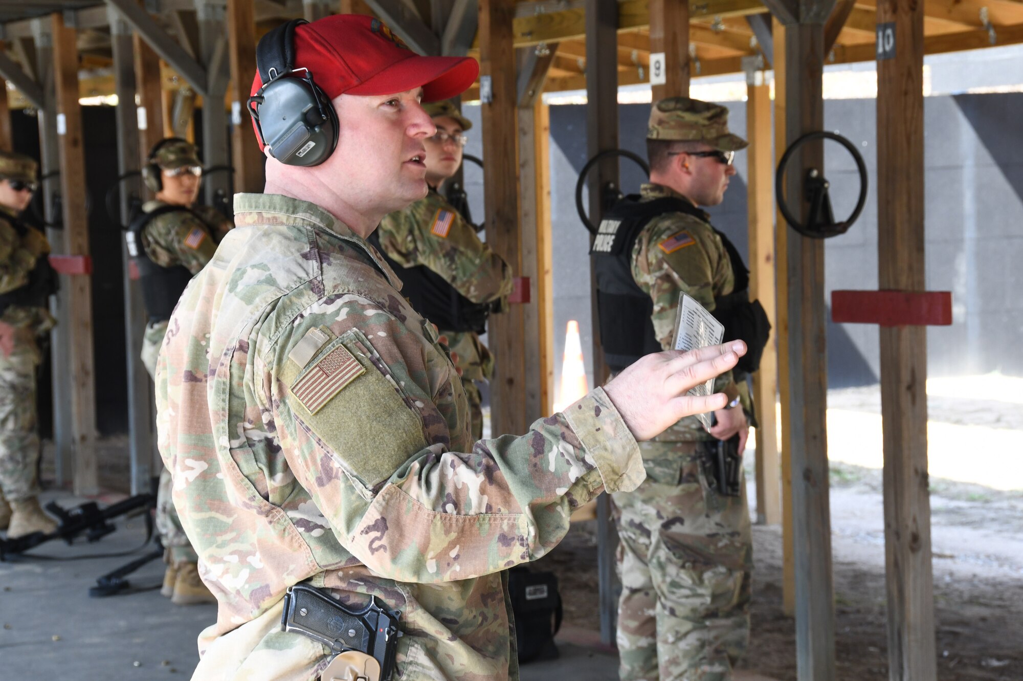 Master Sgt. Christopher Jones, 104th Fighter Wing Combat Arms Training and Maintenance Instructor calls out commands on the firing line to ensure the Infantrymen from 1st Battalion, 182nd Infantry Regiment, Bravo Company, are currently qualified on the M9 pistol. The Massachusetts National Guard Infantrymen are activated in response to COVID-19 to ensure there is enough manpower available to safeguard the 104th Fighter Wing assets and personnel. These precautions are being taken to mitigate any manning shortages that may occur due to unforeseen illness and will allow back up for the wing’s Security Forces. During the pandemic, the infantrymen will be working alongside the 104th Security Forces to reinforce security for the 104th Fighter Wing F-15 homeland defense flying mission to maintain air superiority. (U.S. Air National Guard Photo by Senior Master Sgt. Julie Avey)