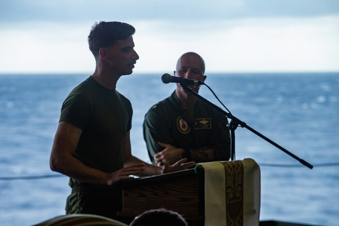A U.S. Marine speaks to Marines and Sailors prior to being baptized during an Easter service aboard amphibious assault ship USS America (LHA 6), April 12.