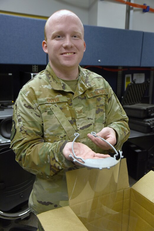 Staff Sgt. Zachary Goyer, with the 552nd Air Control Network Squadron, has been running his personal 3-D printer non-stop for two weeks, making clips to hold plastic face shields for medical workers. His printer makes a new clip about every hour and a half. He's been using overhead transparency sheets or binder covers he's ordered online for the plastic shields. (U.S. Air Force photo/Kelly White)