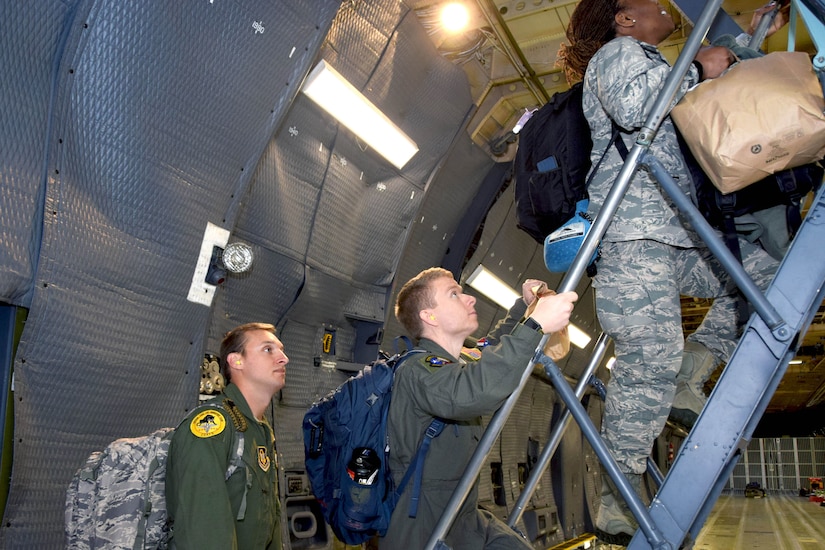 Airmen board a plane.