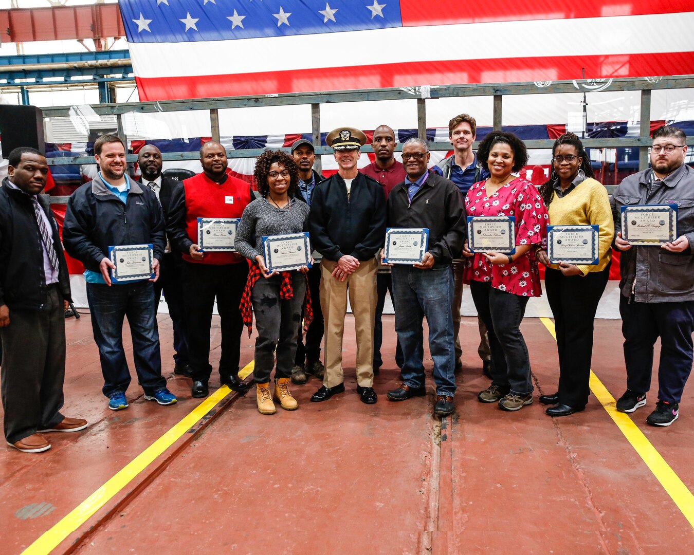 Shipyard Commander Capt. Kai Torkelson with employees who were selected as second quarter force multipliers.