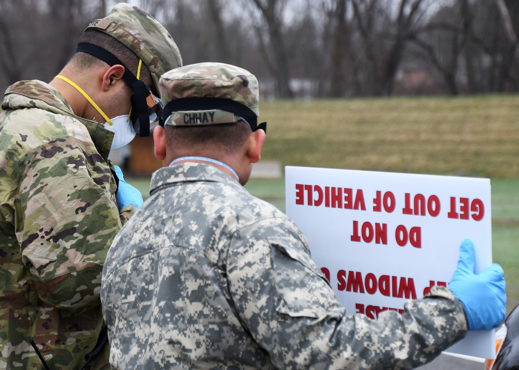 Soldiers from the 26th Maneuver Enhancement Brigade Headquarters and Headquarters Company and the 126th Aviation Battalion help direct cars at a drive-thru COVID-19 testing facility, April 9, 2020, on the Big E fairgrounds in West Springfield, Massachusetts. The soldiers worked with other Massachusetts agencies getting individuals tested. The tested individuals should have their results digitally within 48 hours. (U.S. Air National Guard photo by Airman 1st Class Sara Kolinski)