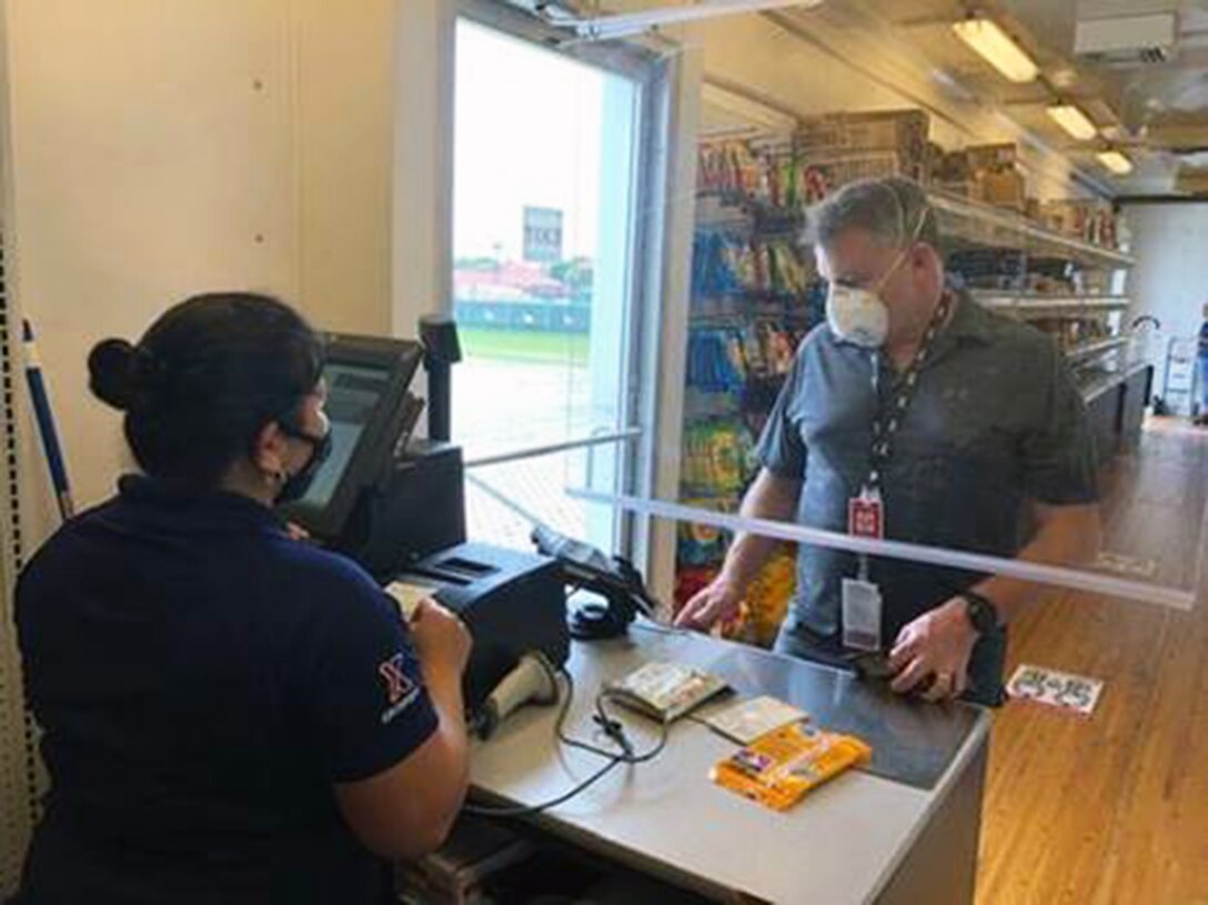 A customer purchases items inside the Mobile Field Exchange trailer at the Mission Training Complex at Joint Base San Antonio-Fort Sam Houston.