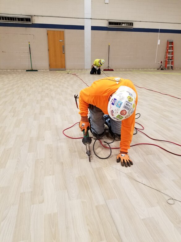 Contractors work on flooring as part of construction at the Bergen New Bridge Medical Center in Paramus, N.J. The U.S. Army Corps of Engineers’ Philadelphia District is working with FEMA and the state to expand capacity at medical facilities as part of the ongoing response to the COVID-19 Pandemic. USACE awarded a contract to Conti Federal Services, LLC to convert the hospital’s gymnasium into a 30-bed facility. Construction began on April 9, 2020.