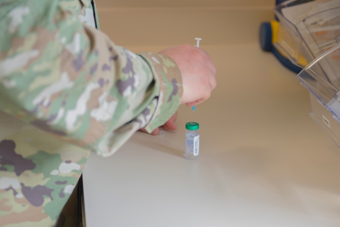 Staff Sgt. Jacob Radford, an allergy and immunizations technician assigned to 628th Health Care Operations Squadron, prepares an injection at the immunizations clinic on Joint Base Charleston S.C., April 7, 2020. Immunizations personnel have been taking safety precautions such as screening all patients before treatment, physical distancing, wearing masks and gloves, frequently cleaning work stations, and washing their hands before and after touching a patient. (U.S. Air Force photo by Airman Sara Jenkins)