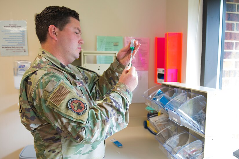 Staff Sgt. Jacob Radford, an allergy and immunizations technician assigned to 628th Health Care Operations Squadron, prepares an injection at the immunizations clinic on Joint Base Charleston S.C., April 7, 2020. Immunizations personnel have been taking safety precautions such as screening all patients before treatment, physical distancing, wearing masks and gloves, frequently cleaning work stations, and washing their hands before and after touching a patient. (U.S. Air Force photo by Airman Sara Jenkins)