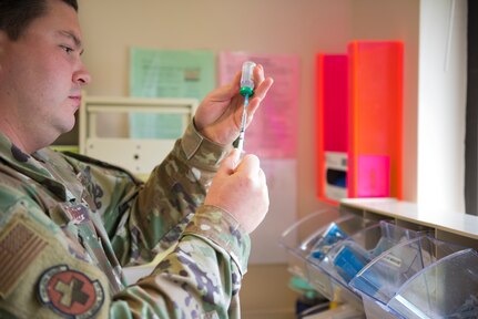 Staff Sgt. Jacob Radford, an allergy and immunizations technician assigned to 628th Health Care Operations Squadron, prepares an injection at the immunizations clinic on Joint Base Charleston S.C., April 7, 2020. Immunizations personnel have been taking safety precautions such as screening all patients before treatment, physical distancing, wearing masks and gloves, frequently cleaning work stations, and washing their hands before and after touching a patient. (U.S. Air Force photo by Airman Sara Jenkins)