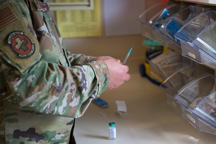 Staff Sgt. Jacob Radford, an allergy and immunizations technician assigned to 628th Health Care Operations Squadron, prepares an injection at the immunizations clinic on Joint Base Charleston S.C., April 7, 2020. Immunizations personnel have been taking safety precautions such as screening all patients before treatment, physical distancing, wearing masks and gloves, frequently cleaning work stations, and washing their hands before and after touching a patient. (U.S. Air Force photo by Airman Sara Jenkins)