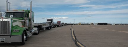 A line of flatbed trucks waits on the BEAR Base ramp on Holloman Air Force Base on April 9, 2020. Airmen from the 635th Materiel Maintenance Group -- the Air Force’s only Basic Expeditionary Airfield Resources unit – loaded more than 30 trucks with 1.2 million pounds of equipment and cargo within 48 hours. This vital equipment is being shipped to Joint Base San Antonio-Lackland, Texas to will help ensure that the Air Force’s basic training pipeline will endure throughout the COVID-19 response. (U.S. Air Force photo by Tech. Sgt. Matthew Rosine)