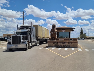 A fully loaded flatbed truck drives out of the BEAR Base gate on Holloman Air Force Base on April 9, 2020. Airmen from the 635th Materiel Maintenance Group -- the Air Force’s only Basic Expeditionary Airfield Resources unit – loaded more than 30 trucks with 1.2 million pounds of equipment and cargo within 48 hours, also deploying more than 30 personnel. This equipment and these personnel are being sent to Joint Base San Antonio-Lackland, Texas to support their contingency billeting capability during the COVID-19 crisis. (U.S. Air Force photo by Lt. Col. Jerry Ottinger)