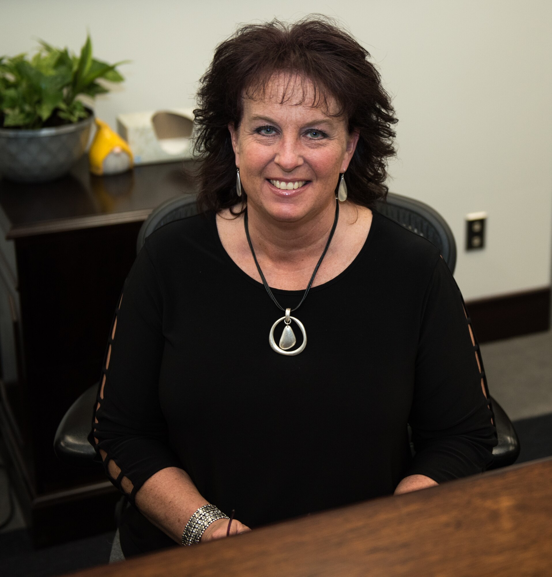 Christine Roop, the 509th Bomb Wing executive assistant to the commander, sits at her desk at Whiteman Air Force Base, Missouri, March 19, 2020. Roop has worked in many jobs at Whiteman AFB over the past 20 years, including being a secretary for the Force Support Squadron and the Mission Support Group. (U.S. Air Force photo by Airman 1st Class Christina Carter)