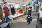 Duane De Lessart, left, a trainer with Code 900T, and Brandon King, middle, a cell manager with Code 1030, screen Ron Arnold, right, Code 600 comptroller, Monday, April 13 as he enters the Decatur Gate to make sure he’s completed his daily COVID-19 self-assessment before starting work at Puget Sound Naval Shipyard & Intermediate Maintenance Facility in Bremerton. (PSNS & IMF photo by Scott Hansen)