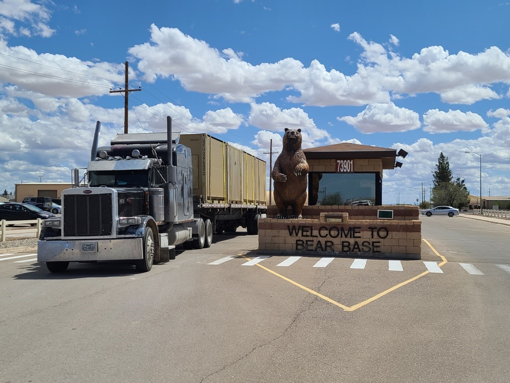 A fully loaded flatbed truck drives out of the BEAR Base gate on Holloman Air Force Base on April 9, 2020. Airmen from the 635th Materiel Maintenance Group -- the Air Force’s only Basic Expeditionary Airfield Resources unit – loaded more than 30 trucks with 1.2 million pounds of equipment and cargo within 48 hours, also deploying more than 30 personnel. This equipment and these personnel are being sent to Joint Base San Antonio-Lackland, Texas to support their contingency billeting capability during the COVID-19 crisis. (U.S. Air Force photo by Lt. Col. Jerry Ottinger)