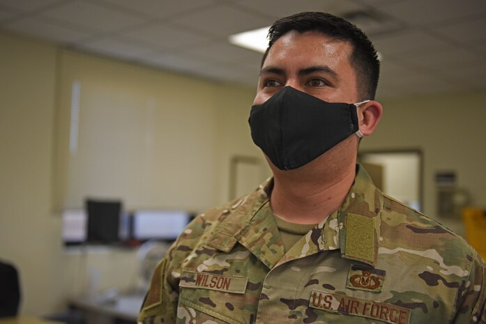 U.S. Air Force Master Sgt. Hansen Wilson, 8th Operations Support Squadron aircrew flight equipment superintendent, dons a cloth mask created by AFE Airmen at Kunsan Air Base, Republic of Korea, April 13, 2020. During the last few weeks, the AFE section has utilized their sewing skills to produce numerous machine-washable cloth mask prototypes; including a generic cloth mask and a more robust, form-fitting mask. (U.S. Air Force photo by Staff Sgt. Mackenzie Mendez)