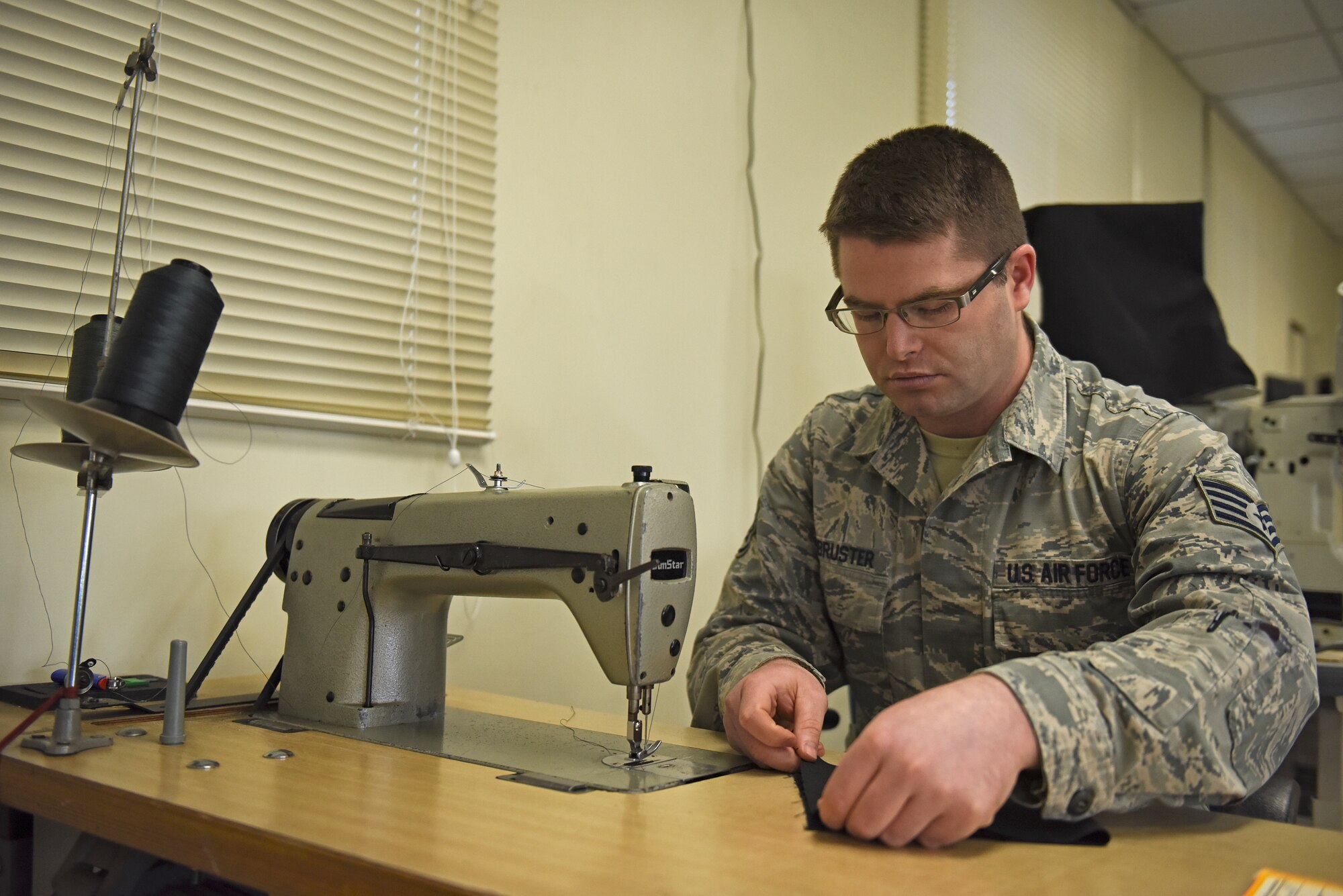 U.S. Air Force Staff Sgt. Nathaniel Armbruster, 8th Operations Support Squadron aircrew flight equipment NCO in charge, prepares to make a cloth mask at Kunsan Air Base, Republic of Korea, April 13, 2020. During the last few weeks, the AFE section has utilized their sewing skills to produce numerous machine-washable cloth mask prototypes; including a generic cloth mask and a more robust, form-fitting mask. (U.S. Air Force photo by Staff Sgt. Mackenzie Mendez)
