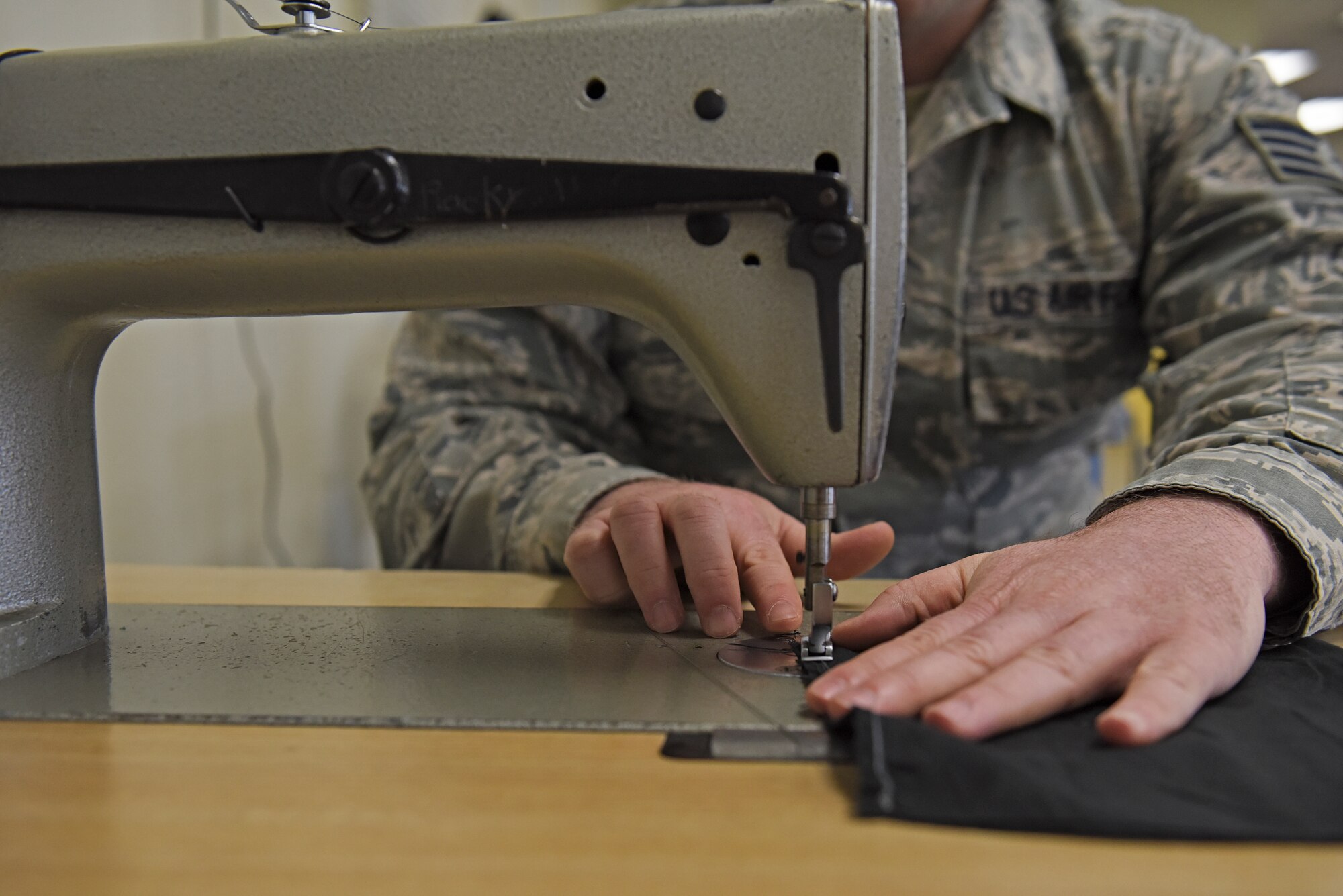 U.S. Air Force Staff Sgt. Nathaniel Armbruster, 8th Operations Support Squadron aircrew flight equipment NCO in charge, creates a cloth mask at Kunsan Air Base, Republic of Korea, April 13, 2020. During the last few weeks, the AFE section has utilized their sewing skills to produce numerous machine-washable cloth mask prototypes; including a generic cloth mask and a more robust, form-fitting mask. (U.S. Air Force photo by Staff Sgt. Mackenzie Mendez)