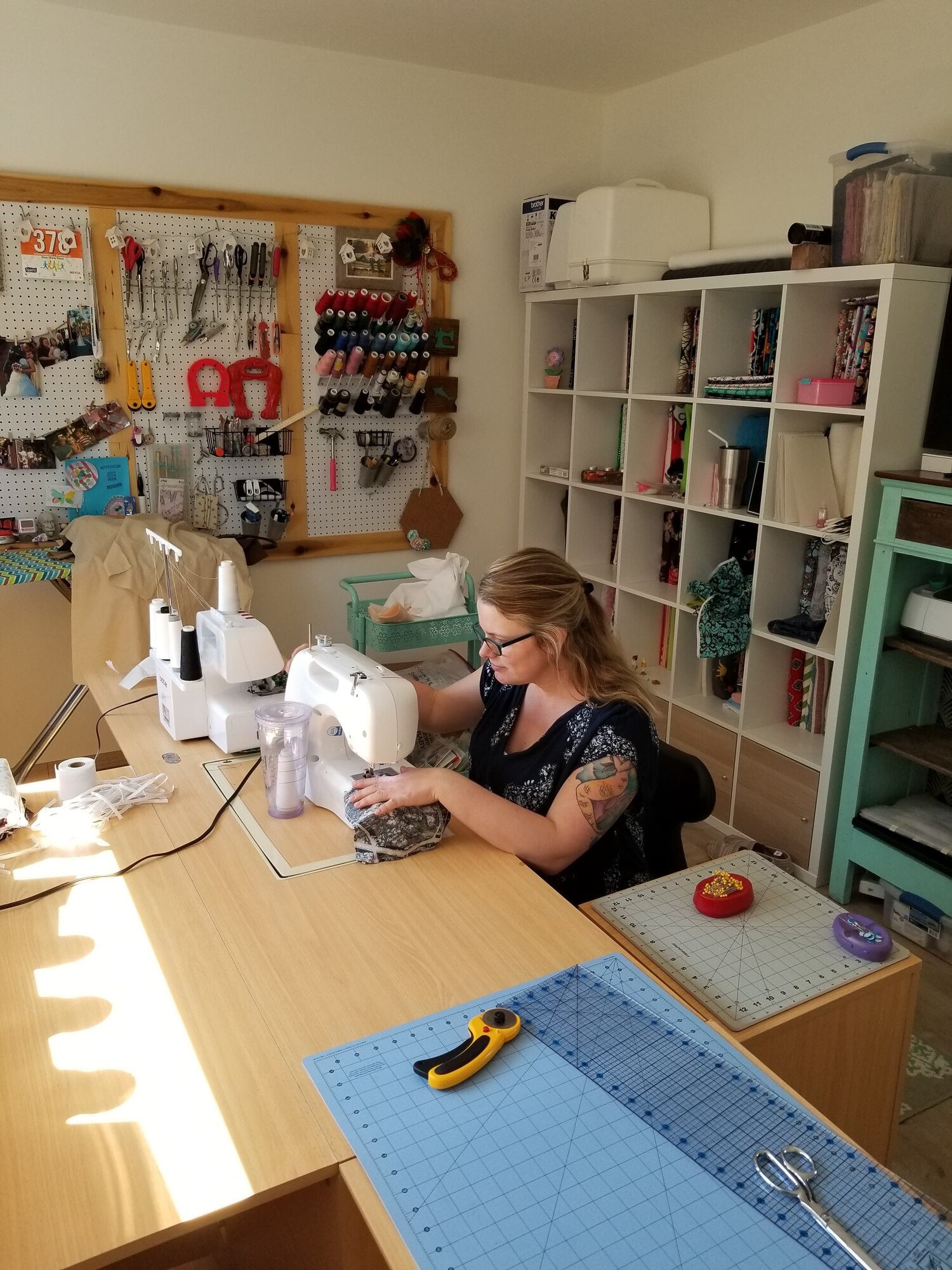 Sarah Schrader, spouse to U.S. Air Force Master Sgt. Jonathon Schrader, 701st Munitions Squadron senior load monitor, uses her sewing machine at Kleine-Brogel Air Base, Belgium, April 6, 2020. Schrader volunteered to make face masks for local hospitals and base personnel to help combat COVID-19. (Courtesy photo from 701st MUNSS.)