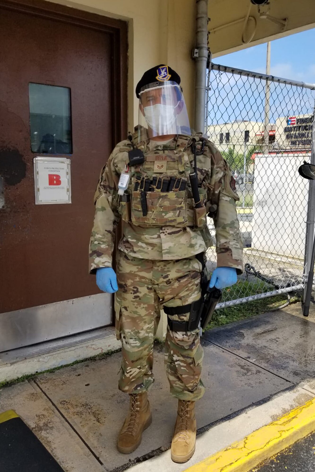 U.S. Air Force Staff Sgt. Alejandro Oyola with the 156th Security Forces Squadron checks identification at the entrance to Muñiz Air National Guard Base, Puerto Rico Air National Guard, while wearing personal protective equipment, April 9, 2020. The 156th SFS Defenders now have plastic face shields, created by 1st Lt. Jose Arroyo, a cyberspace operations officer with the 156th Communications Flight.