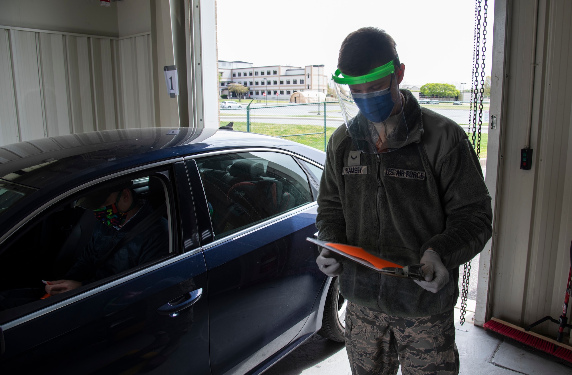 Airman 1st Class Trent Ramsey, 436th Aerial Port Squadron air transportation cargo processor, completes a medical screening while wearing a 3D printed face shield April 10, 2020 at Dover Air Force Base, Delaware. The face shields were printed by the Dover Air Force Base Innovation Lab "BEDROCK" for use by medical and security forces personnel supporting COVID-19 response efforts.  (U.S. Air Force photo by Airman 1st Class Jonathan Harding)