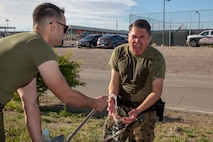 Lance Corporal Jeremy J. Tom, warehouse clerk, screams in pain as Lance Cpl. Noah M. Avila, data systems administrator, tries to help him by spraying him with cold water, after Tom was sprayed with OC spray as part of the Security Augmentation Force training held aboard Marine Corps Logistics Base Barstow, Calif., April 1.