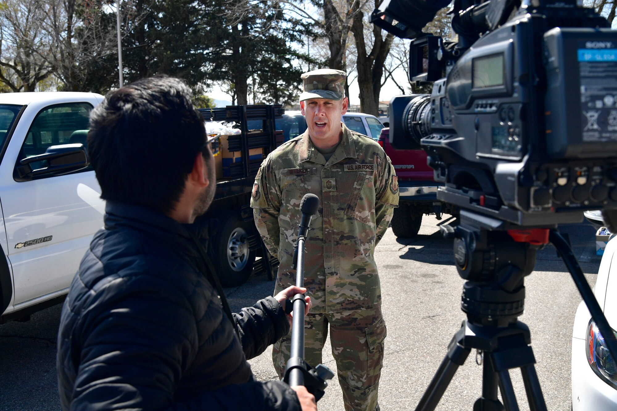 Chief Master Sgt. Christopher Walker, 75th Air Base Wing Command Chief, is interviewed by FOX 13 News, after being presented with thousands of donated face masks for the base military and civilian Airman personnel.