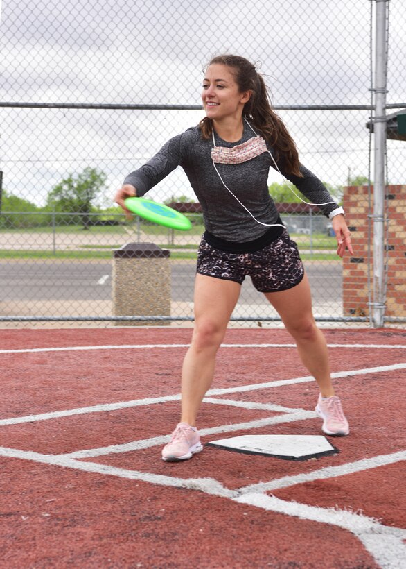 A student at the 315th Training Squadron Amelia Feuka, competes in the disc toss event during the 315th TRS ‘Break the Pandemic’ event on Goodfellow Air Force Base, Texas, April 11, 2020. In response to social restrictions due to COVID-19, the 315th TRS decided to organize an event to ensure the mental and physical well-being for Goodfellow members. (U.S. Air Force photo by Staff Sgt. Chad Warren)