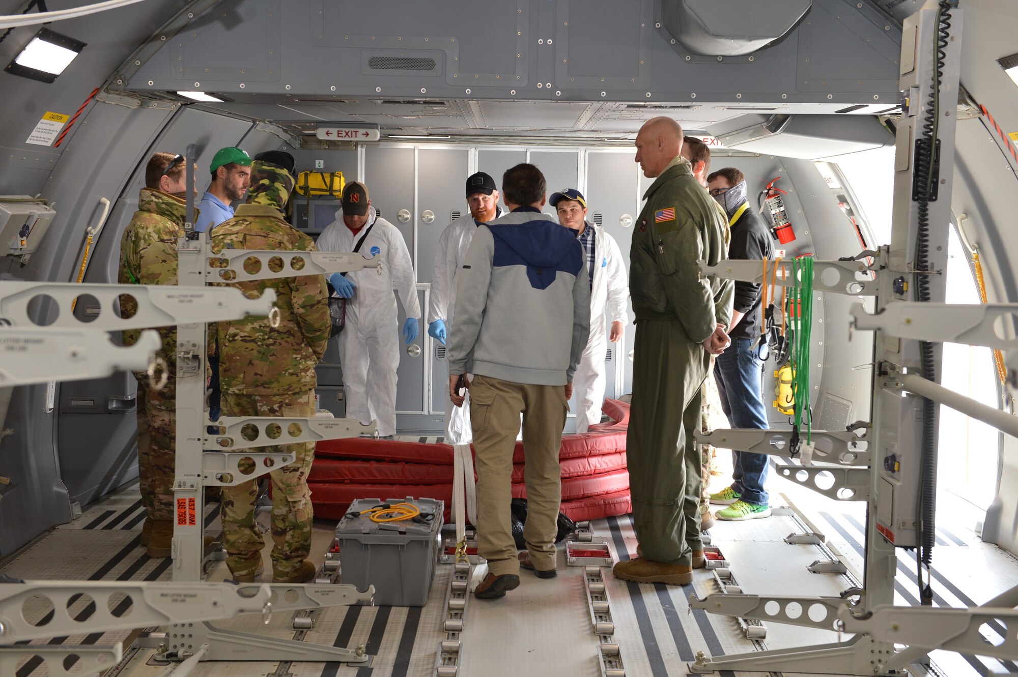 Members from the University of Nebraska’s National Strategic Research Institute, KC-46 Pegasus crew members and 155th Air Refueling Wing Airmen discuss airflow particle test results at the 155th ARW, Nebraska National Guard air base, Lincoln, Nebraska, April 10, 2020. The U.S. Air Force Air Mobility Command, the university's medical center and the Defense Advanced Research Projects Agency examined airflow to assess ways to eliminate virus transmission to aircrew when transporting COVID-19 patients.