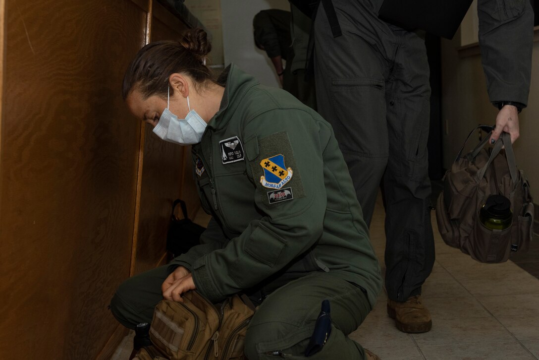 Maj. Roni Yadlin, 9th Bomb Squadron assistant director of operations, preps her bag after a pre-flight brief at Dyess Air Force Base, Texas, April 10, 2020.