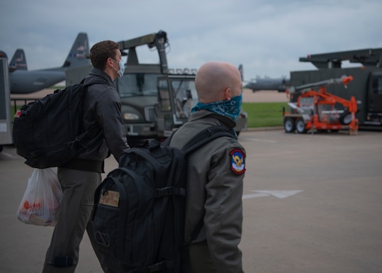 Capt. Joshua Wiesner (left) and Capt. Kenneth Baird (right), both 39th Airlift Squadron pilots, walk on the flightline toward a C-130J Super Hercules aircraft to conduct a training sortie on Dyess Air Force Base, Texas, April 9, 2020.