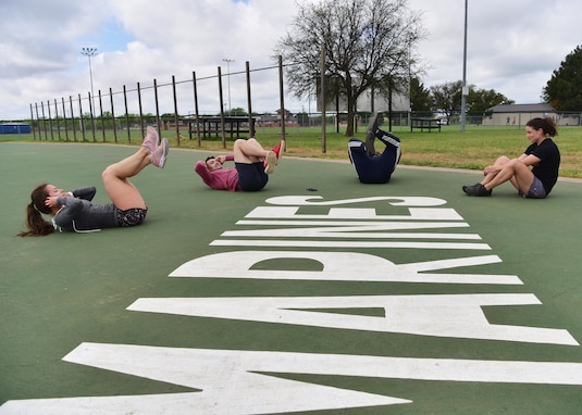 Members of ‘Dream Team’, one of the competition winners, compete in the sit-up portion of the ‘Break the Pandemic’ Morale event on Goodfellow Air Force Base, Texas, April 11, 2020. The 315th Training Squadron hosted the event to give members of Team Goodfellow a way to interact while observing social distancing regulations in response to the COVID-19 pandemic. (U.S. Air Force photo by Staff Sgt. Chad Warren)