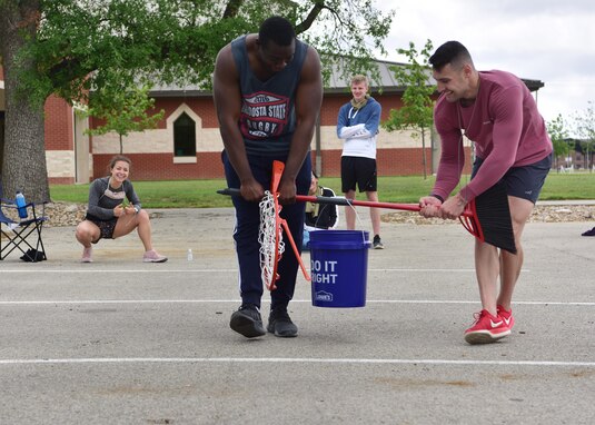 A team of 315th Training Squadron students competes in the water bucket challenge portion of the ‘Break the Pandemic’ Morale event on Goodfellow Air Force Base, Texas, April 11, 2020. The event consisted of a variety of items the team had to use to move a full water bucket while maintaining proper social distancing. (U.S. Air Force photo by Staff Sgt. Chad Warren)