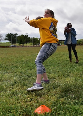 A team of Airmen competes in the football punt, pass and kick portion of the ‘Break the Pandemic’ Morale event on Goodfellow Air Force Base, Texas, April 11, 2020. The 315th Training Squadron hosted the event, in which teams competed in eight different physical and mental challenges in order to escape the monotony of social distancing regulations in response to the COVID-19 pandemic. (U.S. Air Force photo by Staff Sgt. Chad Warren)