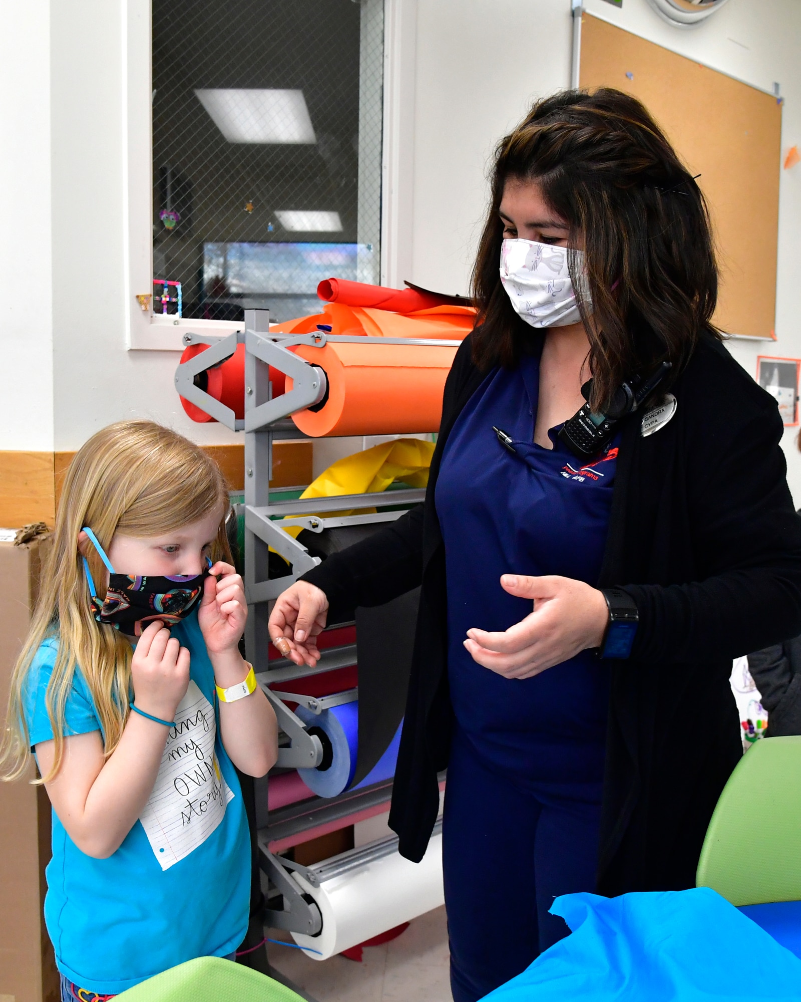 Bethany Powell, left, try’s on a completed mask with Sandra Edelman.
