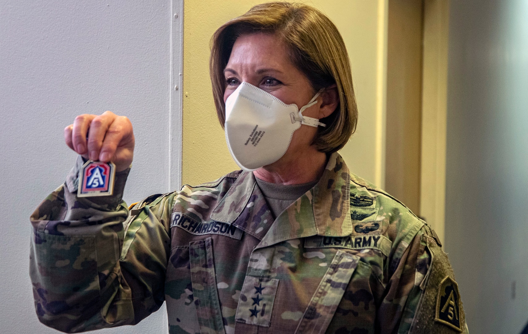 Lt. Gen. Laura Richardson, commanding general of U.S. Army North, presents coins to Soldiers during her visit to the Edison Field Medical Site in Edison, New Jersey, April 13, 2020.