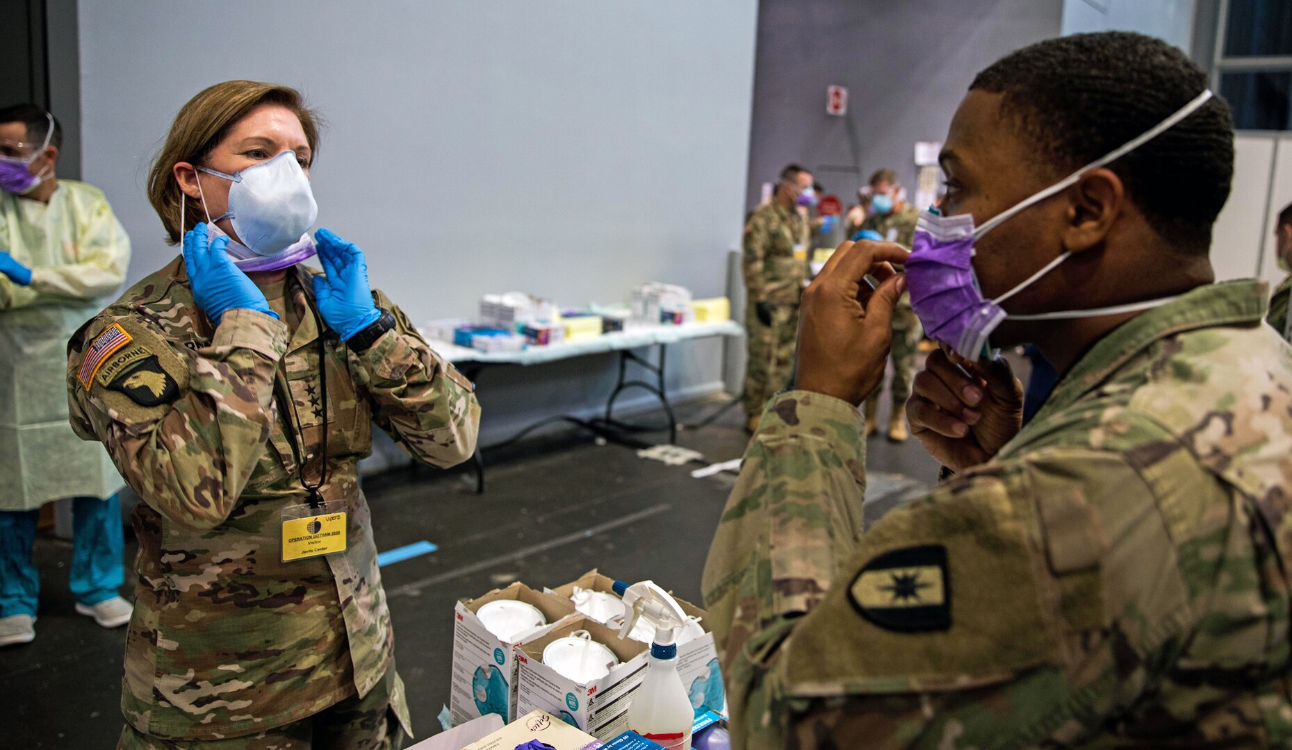 Army Lt. Gen. Laura Richardson, commanding general of U.S. Army North, puts on personal protective equipment before entering the patient care area at Javits New York Medical Station, April 12, 2020.