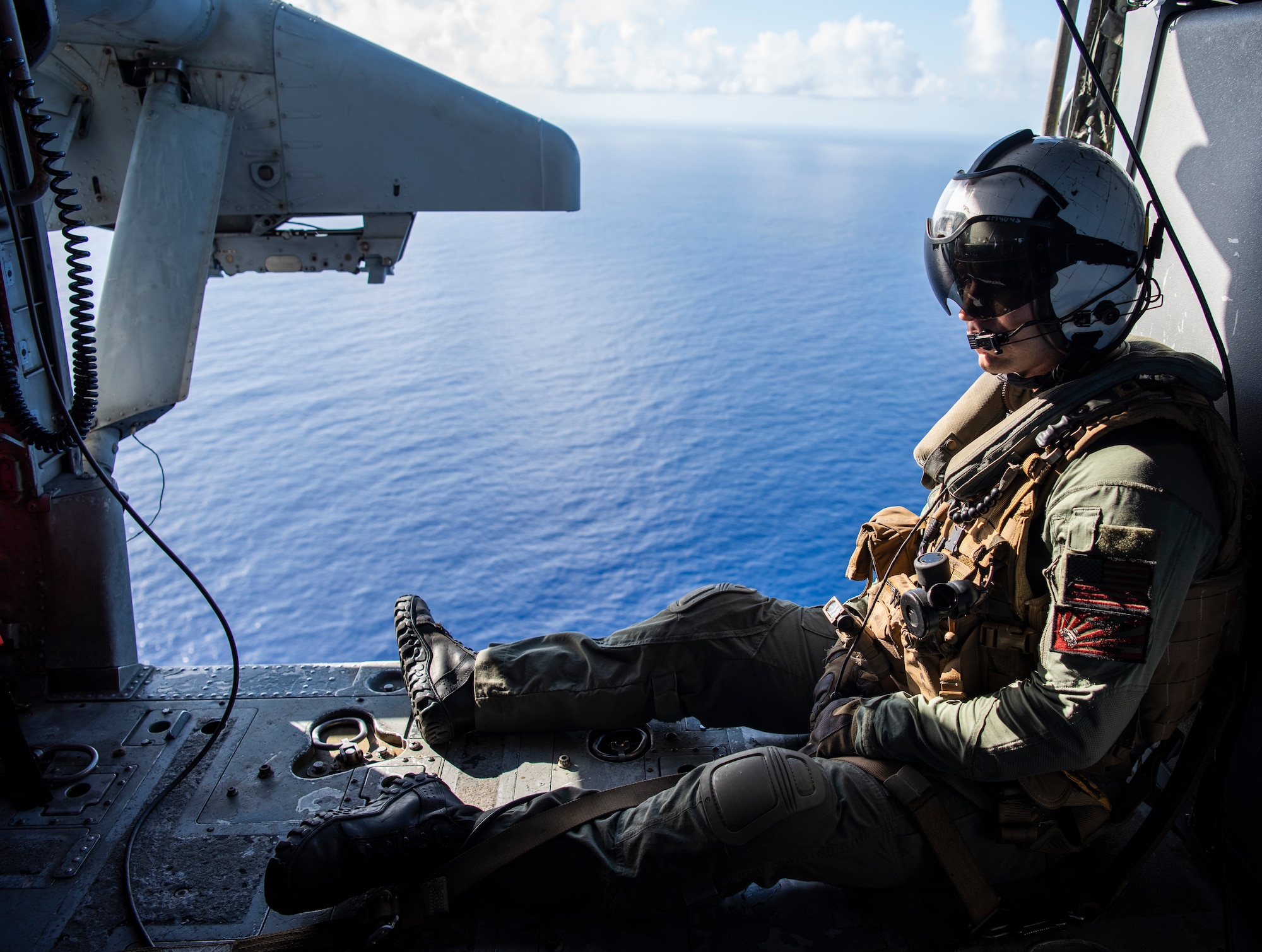 U.S. Navy Air Crewman 2nd Class Zach Morrissey, assigned to Helicopter Sea Combat Squadron 25, prepares to travel over Andersen Air Force Base, Guam, during an “Elephant Walk” in an MH-60S Knighthawk over the Pacific Ocean, April 13, 2020.